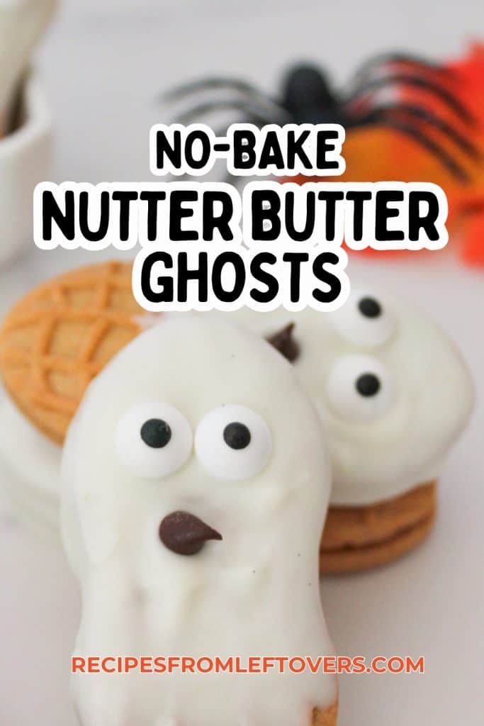 Two Nutter Butter cookies coated in white icing with candy eyes and chocolate mouth, designed to resemble ghosts, are displayed in front of plain Nutter Butter cookies. The text “No-Bake Nutter Butter Ghosts” overlays the image.